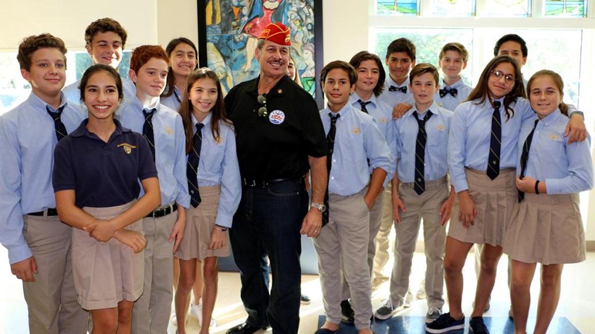 Palmer Trinity School’s staff and students, with Miami-Dade Commissioner Jose “Pepe” Diaz, center, recently honored veterans from all branches of the United States Armed Forces with a special ceremony and breakfast.