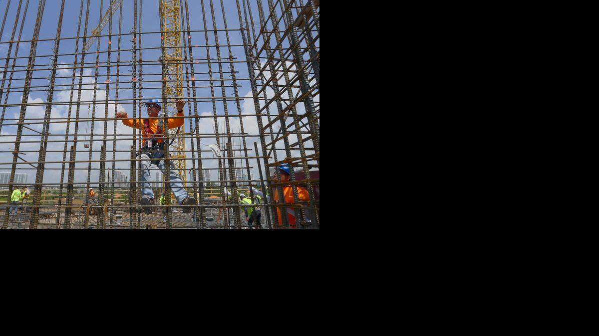 
Construction workers place rebar on the fifth floor of the Porsche Design Tower. The 60-story super high-end luxury condo which is selling units to billionaire buyers from around the globe, is underway on Tuesday, June 24, 2014 in Sunny Isles Beach, Florida.
