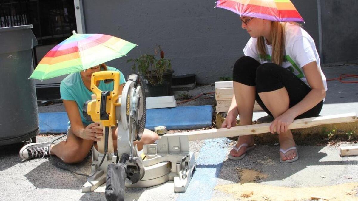 Daniela Cruz, 16, left, and Catie Schwartzman, 17, put the finishing touches on pieces of a sculpture they're building for their first group exhibition through the LAB: Locust Art Builders program. Opening night is on Saturday, July 9, at Locust Projects in Miami's Design District.
