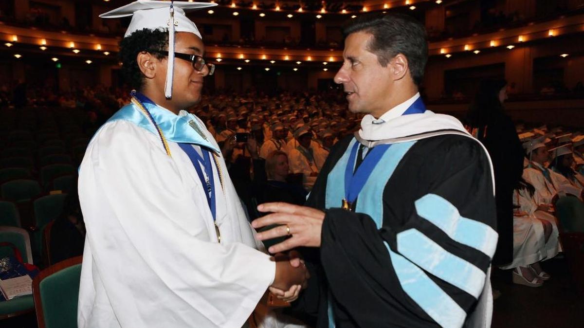 Superintendent of Miami-Dade County Public Schools Alberto Carvalho speaks with student Norberto Orellana during the graduation ceremony for the School of Advanced Studies at the Adrienne Arsht Center for the Performing Arts on Thursday, June 9, 2016.