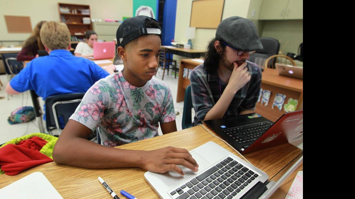 
Zachri Hall, left, and Gabriel Sanchez study coding at a pre-college academy offered over the summer by Palmer Trinity School in Palmetto Bay, which teamed up with the Flatiron School.
