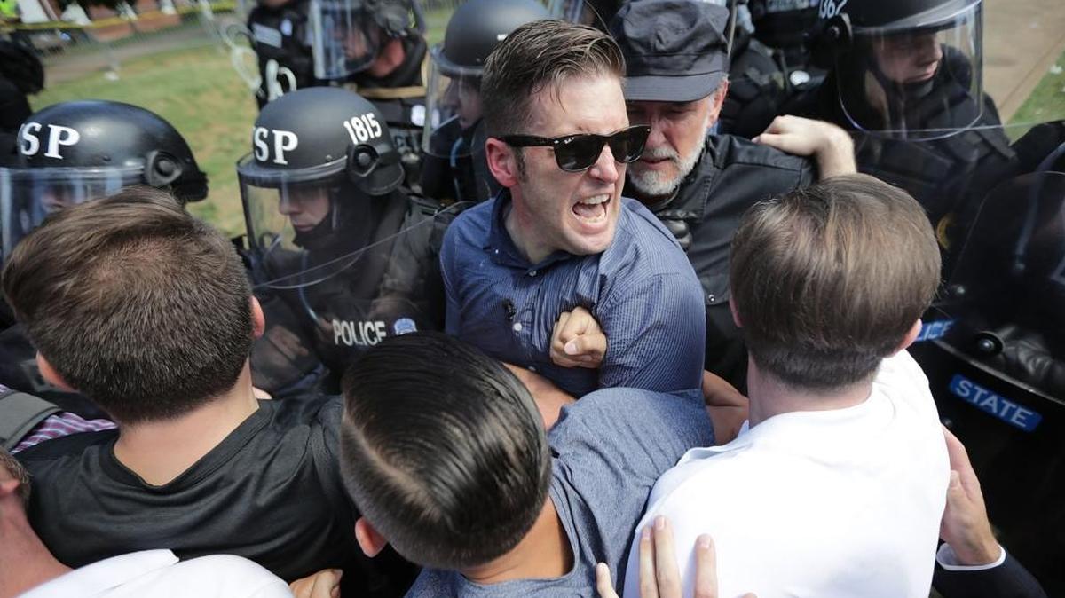 CHARLOTTESVILLE, VA - AUGUST 12: White nationalist Richard Spencer (C) and his supporters clash with Virginia State Police in Lee Park after the "United the Right" rally was declared an unlawful gathering August 12, 2017 in Charlottesville, Virginia. Hundreds of white nationalists, neo-Nazis and members of the "alt-right" clashed with anti-facist protesters and police as they attempted to hold a rally in Lee Park, where a statue of Confederate General Robert E. Lee is slated to be removed.
