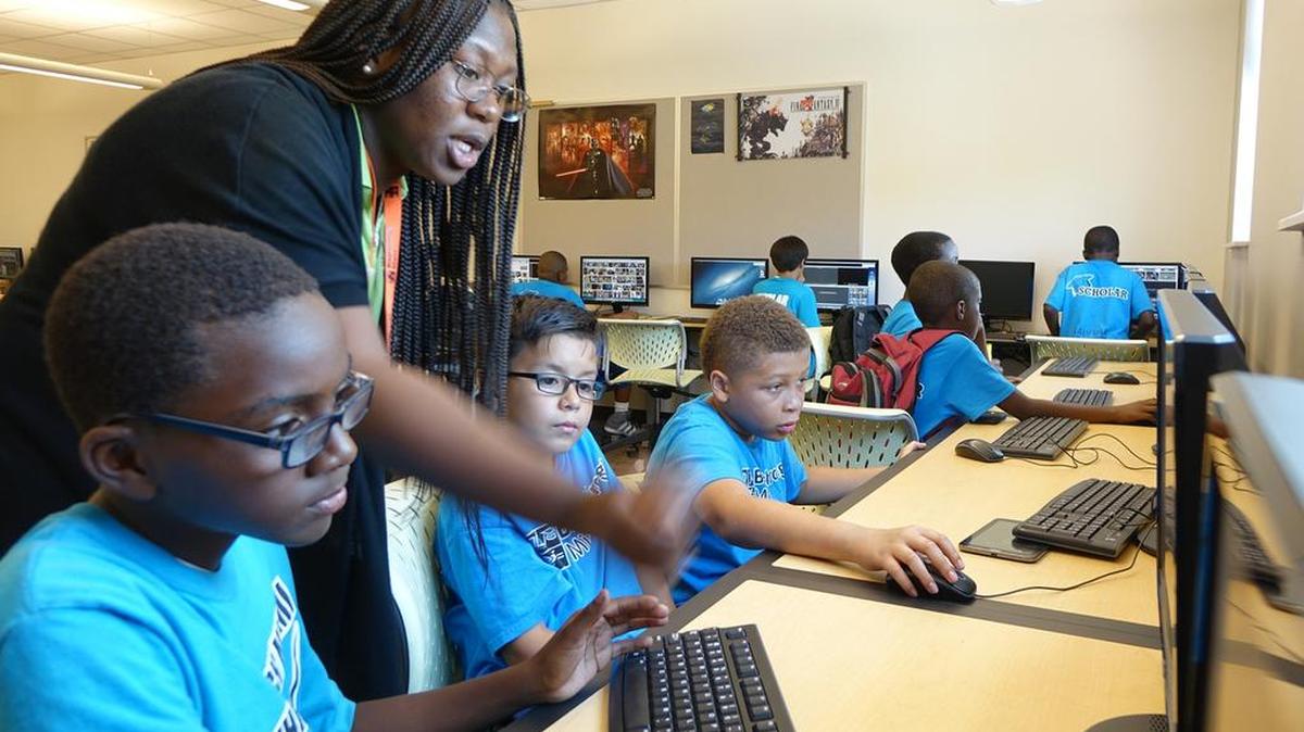 
Teaching fellow Shanava Saintolein instructs Breakthrough Miami Scholars Cornell Stewart, Jamari Cooley and Manuel Medina in her TV broadcasting elective she taught this summer at the Breakthrough Miami Summer Institute site at Miami Country Day School. 

