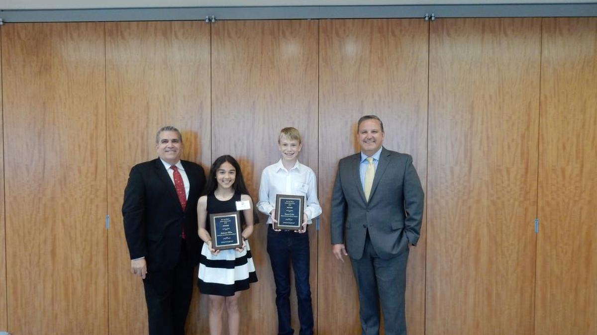 Miami-Dade County Public Defender Carlos Martinez and Holland & Knight partner Eduardo Ramos with the 2016 Do the Write Thing essay contest winners Ariana Silva Falcon and James Critz. The two middle school students were recognized out of 325 students for their essays about youth violence.