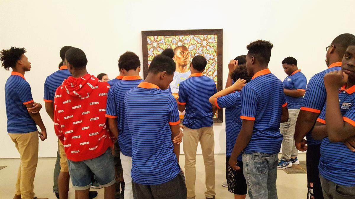 Black Male College Explorers listen as they are taught about art that's part of PAMM’s new exhibit, ‘The World’s Game: Fútbol and Contemporary Art.’