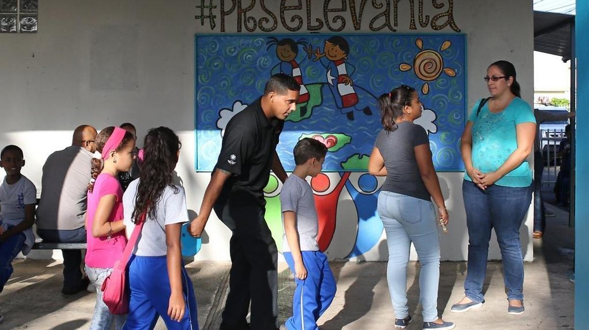 Parents and students walk into the Julio Selles Sola Elementary School in Rio Piedras, a neighborhood of San Juan, Puerto Rico, on Tuesday, October 24, 2017.