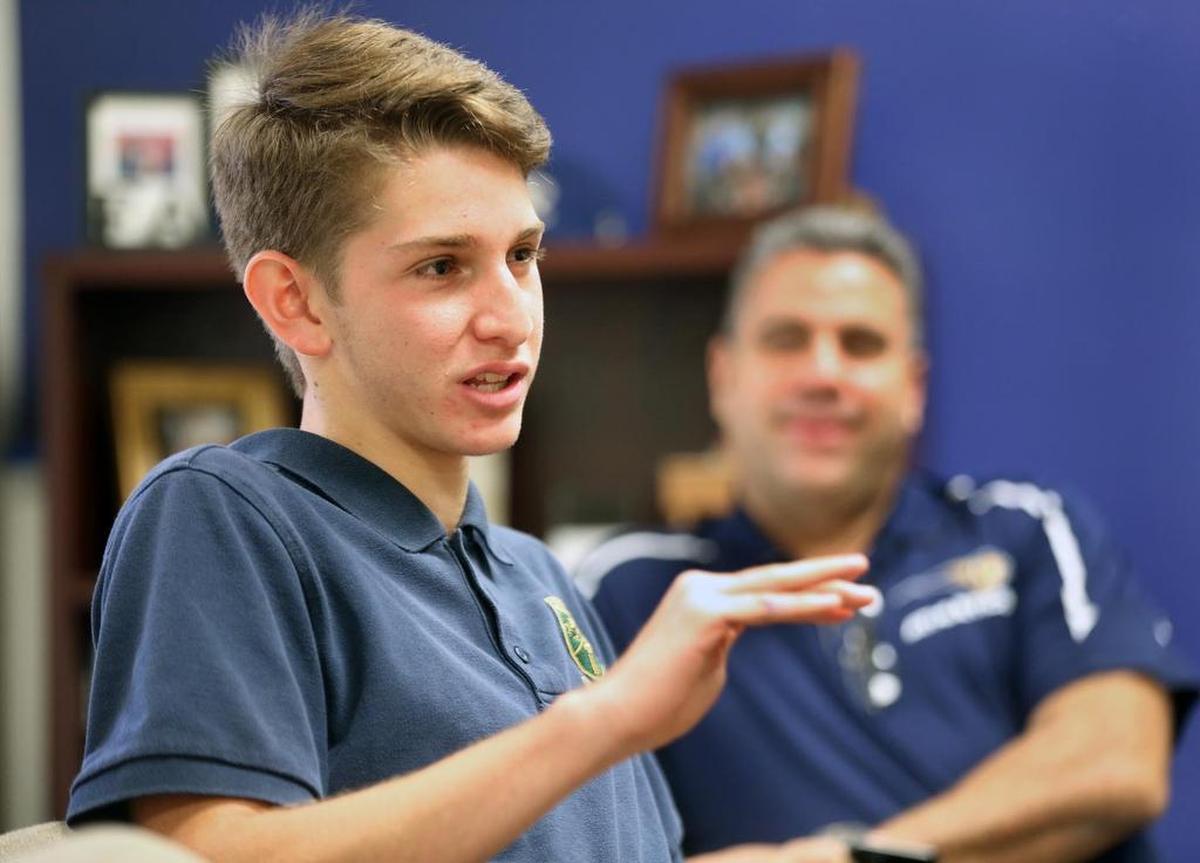 Friday, August 25, 2017- Antonio Bonaduce, an 18-year-old recent arrival from Venezuela, talks about his experience so far attending Ronald W. Reagan Doral Senior High School as Principal Juan Carlos Bouè looks on. Antonio is part of a new influx of Venezuelan students being introduced into the Miami-Dade school system.