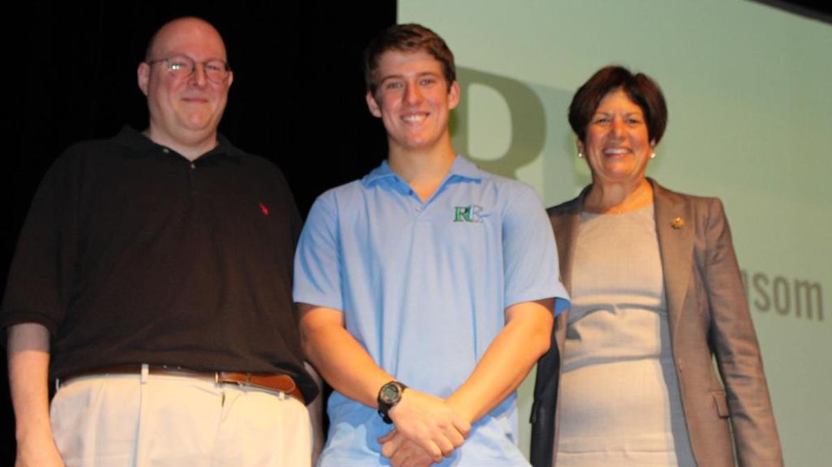 Ransom Everglades School student John Mistele was one of 11 to earn a perfect score on the nationwide Advanced Placement Calculus BC Exam. He was honored by his math teacher Henry Stavisky, left, Head of School Penny Townsend and his peers during an assembly at the Lewis Family Auditorium.