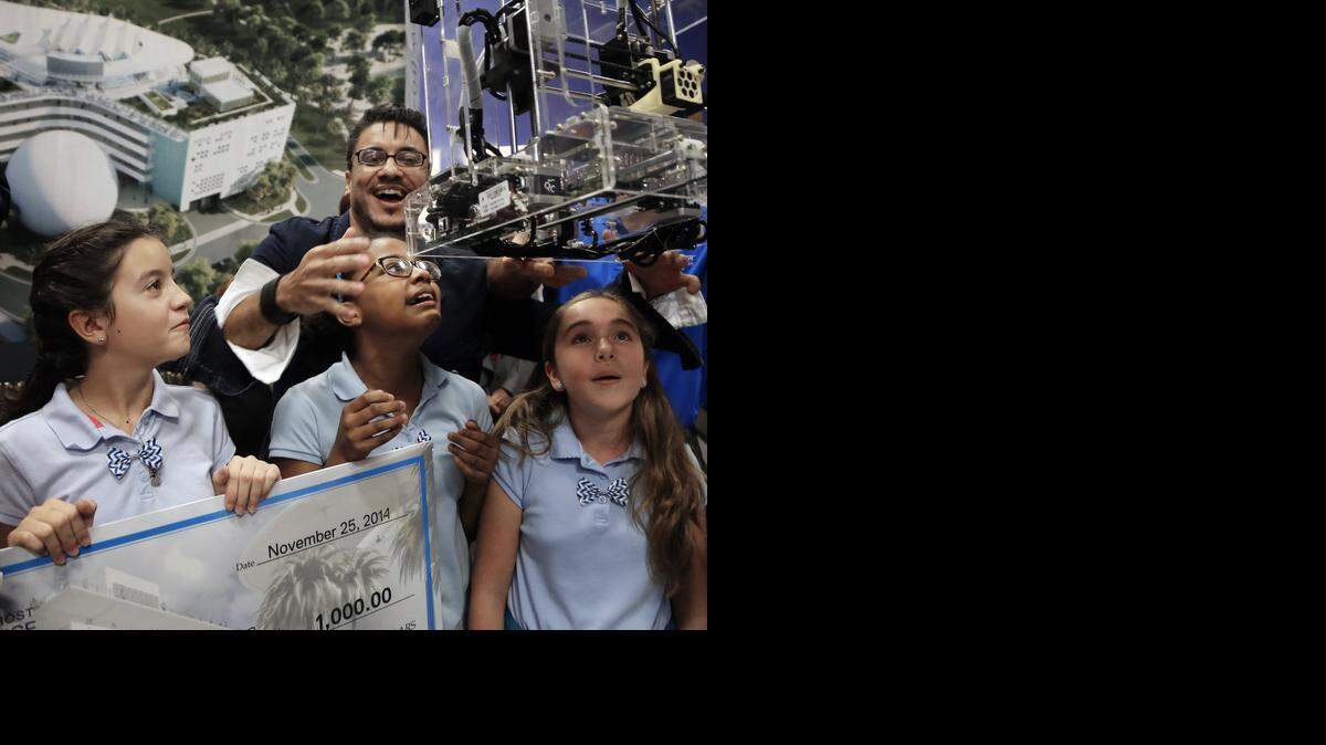 
The contest, sponsored by the Patricia and Phillip Frost Museum of Science, challenged young fashion designers and aspiring engineers to design footwear that showcased art, science and technologystudents, from left to right, Cristina Montes, 11, Nyla Crawford, 11, and Daniela Ferdele, 11, react as designer Luis Valenzuela presents their winning team with a 3D printer. The contest, sponsored by the Patricia and Phillip Frost Museum of Science, challenged young fashion designers and aspiring engineers to design footwear that showcased art, science and technology.


