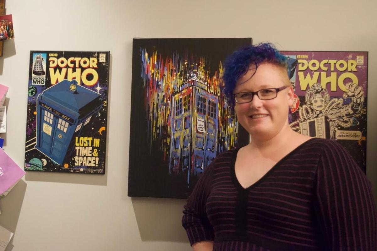 Master Teacher Amee Hall in her classroom, decorated with Doctor Who frames, at Fusion Academy.
