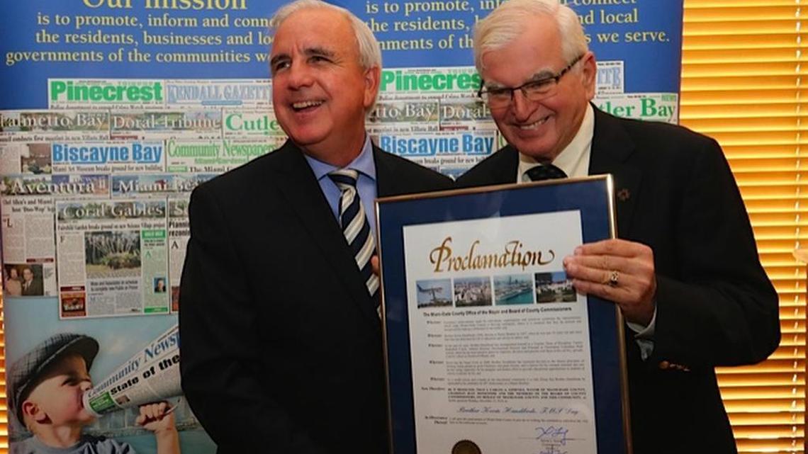 Miami-Dade County Mayor Carlos Gimenez honored Brother Kevin Handibode for his service to Catholic education.