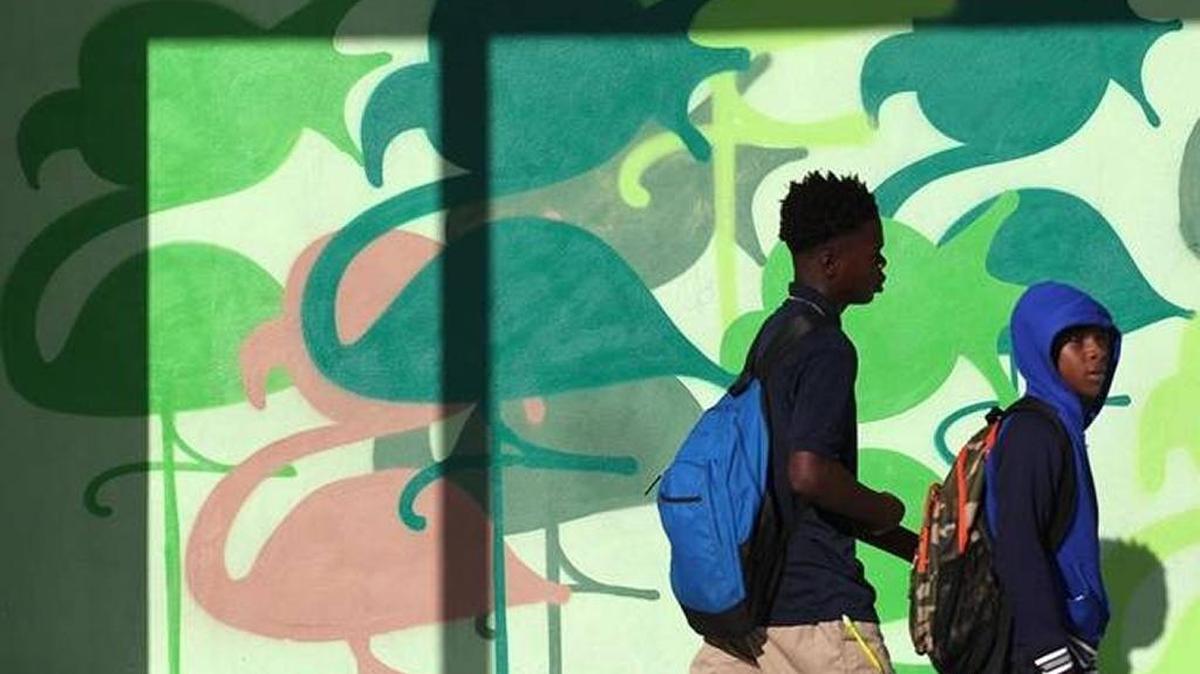 Students pass a mural in Miami on the first day of school. A new study found that Miami has the highest concentration of highly segregated schools in the state.