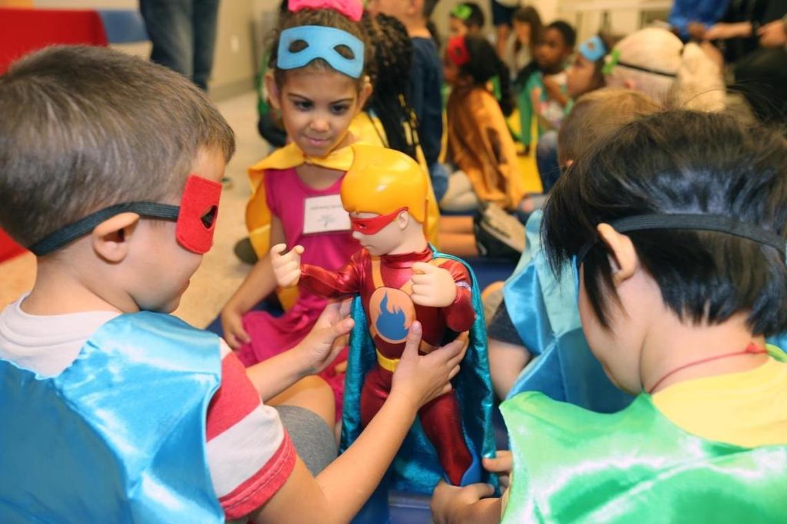 Camila Desangles (center), Bryan Hernandez (left rear) and Sanny Chang Feng (right rear), at the Miami Lighthouse for the Blind and Visually Impaired during a visit by the co-founder of The HeroBoys comics on Wednesday, June 28, 2017. The HeroBoys, subjects of a new line of comic books and toys, visited the Miami Lighthouse to celebrate adventure, imagination, and limitless potential with blind children.