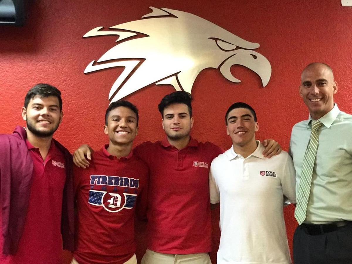 From left: Doral Academy 11th graders Juan Torres, German Fernandez, Juan Laguado, Ariel Garcia and Principal Carlos Ferralls.