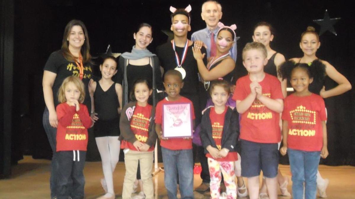 Author David Ira Rottenberg visited Howard Drive Elementary School to read his book, ‘Gwendolyn, the Graceful Pig,’ to students in Pre-K to fifth grade. The presentation included a performance by local ballet students from Focal Point Dance Studio. Pictured from left: Annette Diaz, Alexandra Taubas, Emerich Ligonde, Rottenberg, Jojo Funderburk, Megan Bentley, Sara Awada, Adriano Shapiro, Olivia Fraginals, Ryan Hall, Aubrey Delgado, Max Cannings and Victoria Cardenas.