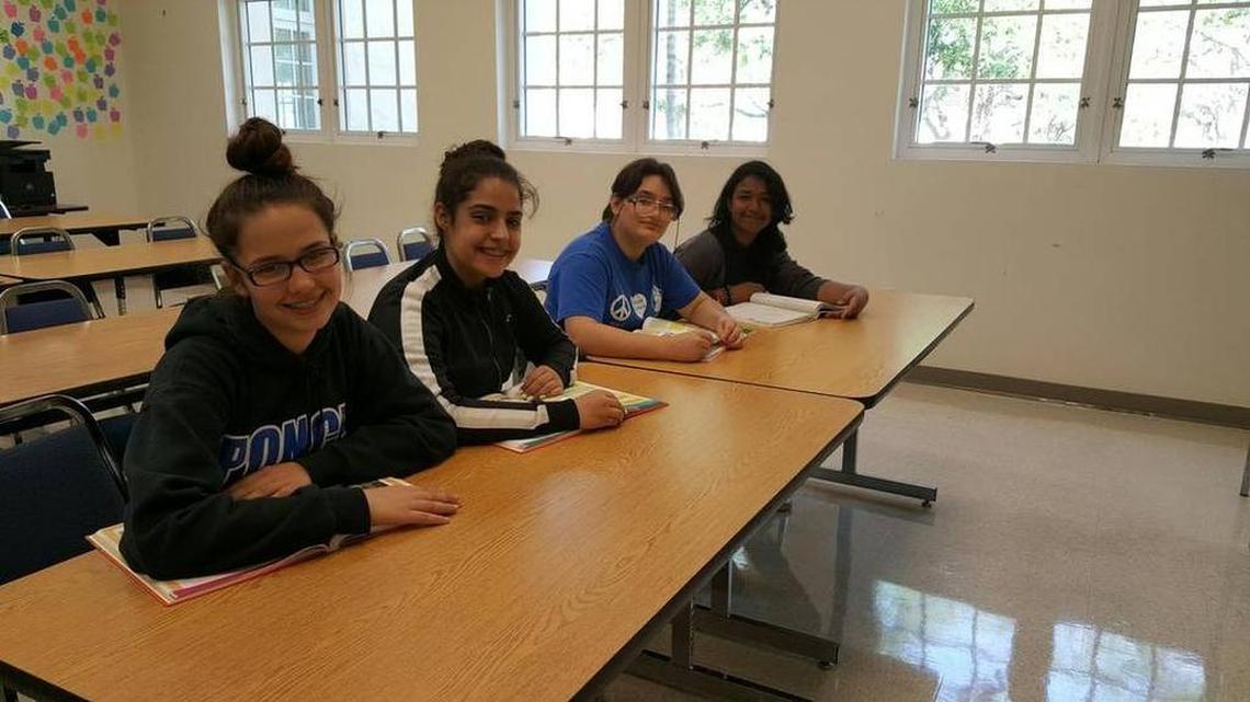 Students Addys Plata, Hanna Ebrahimi, Daymara Fernández and Cristina Palacios are part of a group of students at Ponce de Leon Middle School who are enrolled in a college class.