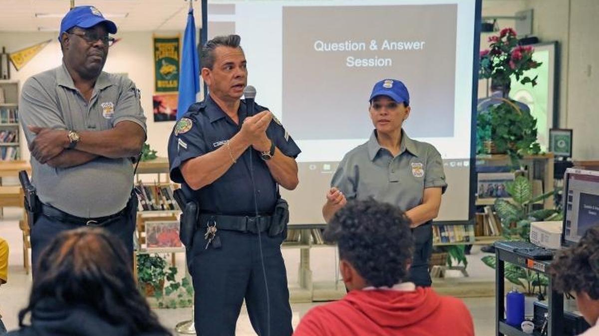 School police officers are among those to whom students can go to report inappropriate sexual behavior. In this photo from March 21, 2017, Resource Officer Leon Leonard, Officer Leonardo Carillo and Officer Claudia Beltrand from Miami-Dade County Public Schools, speak to students at Miami Jackson High School on how to respond to police when they get pulled over for a routine traffic stop.