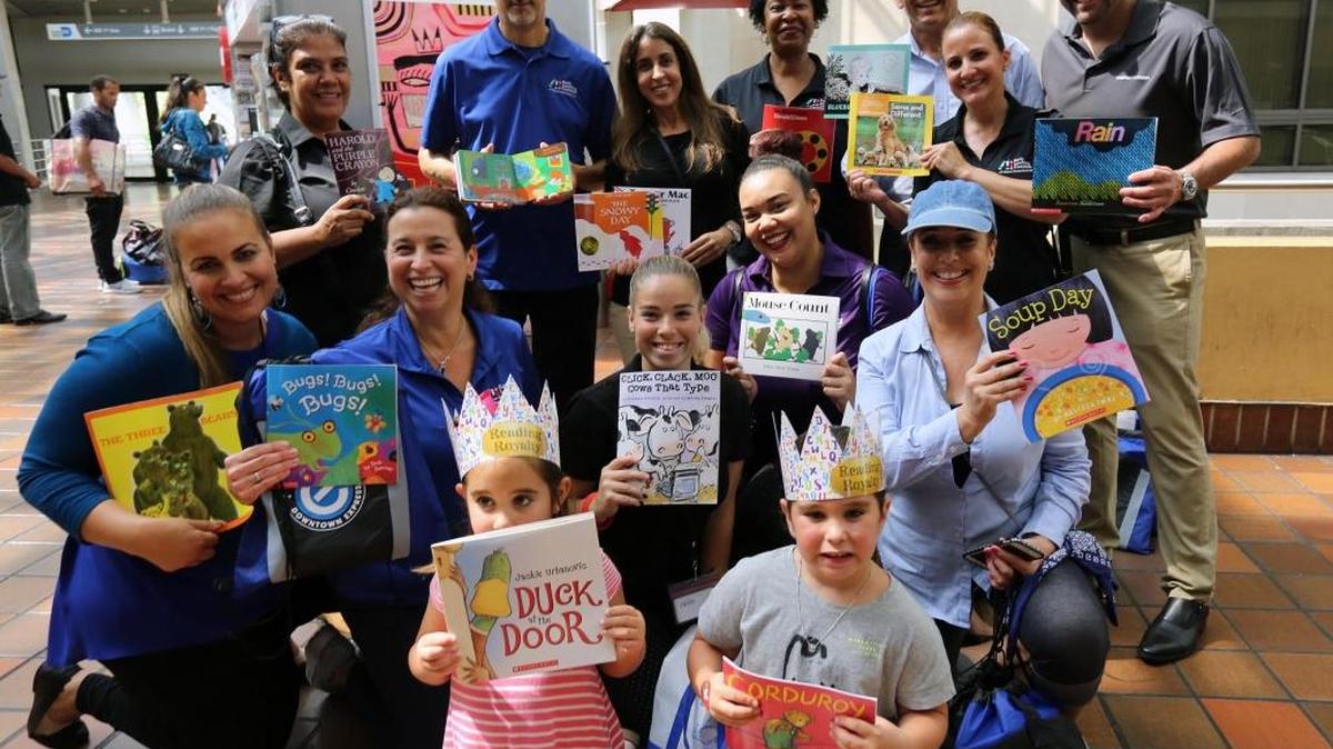 A group of volunteers and executives from the Early Learning Coalition at the government center on Thursday, June 8, 2017, during a “Read and Ride” event to spread awareness of summer literacy.