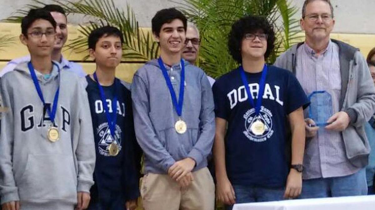 Doral Charter Academy students stand with their coach, Sam Koski, after winning first place in the Meeting of the Minds math competition, held at Miami Dade College.