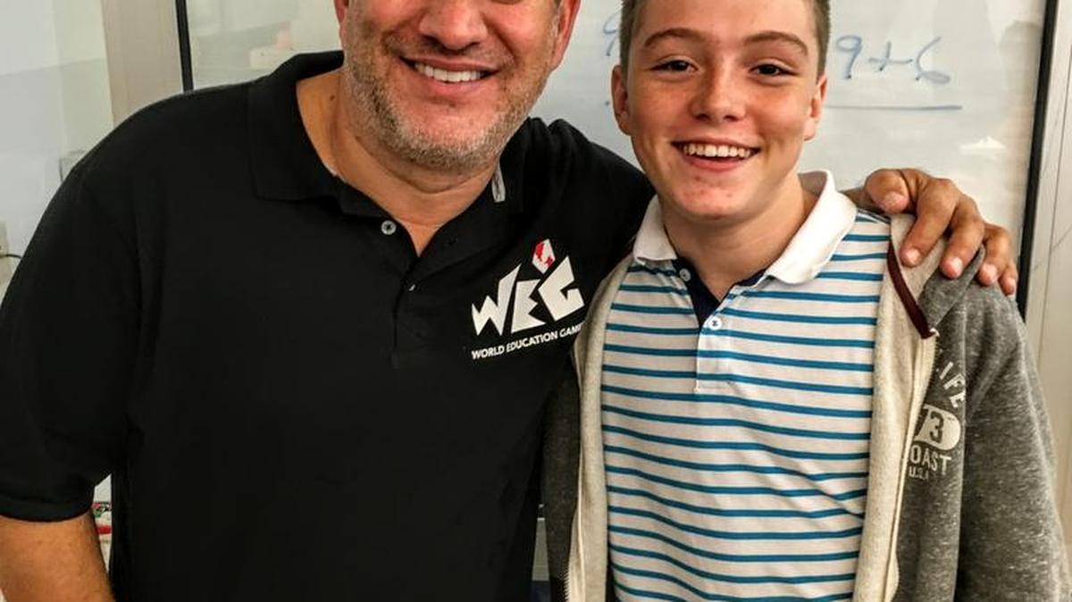 Luke Walsh meets Scott Flansburg in New York City at the World Education Games. Flansburg was added to the Guinness Book of World Records in 2001 for adding the same number to itself more times in 15 seconds than a person using a calculator.
