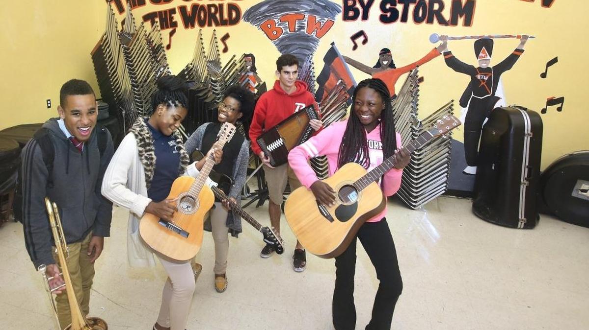 From left, Booker T. Washington High band members freshman Tyrese Williams, 14, left, seniors Natarsha Simeon, 19, and Diamond Williams, 18, and junior Violette Fatale, 16, and jam with Miami Beach High sophomore Benjamin Dietch, 16, (back).