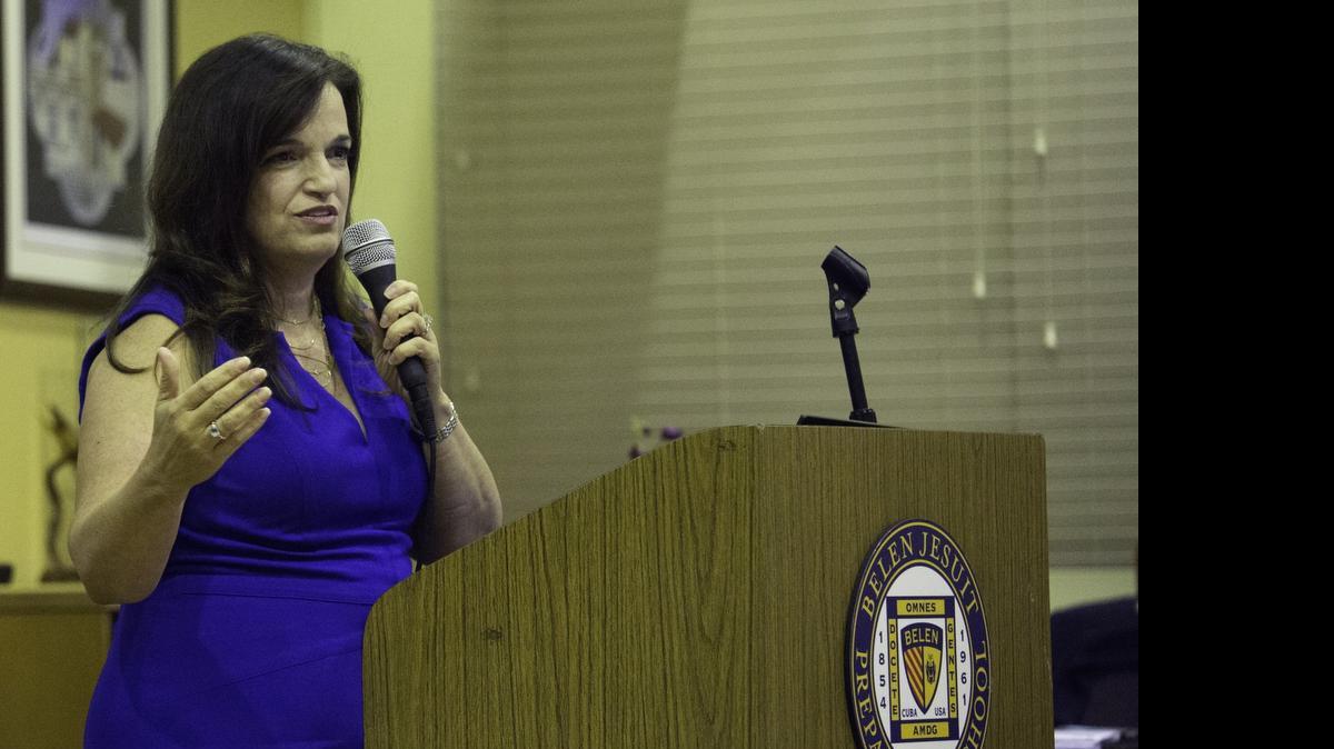 
Zeida Sardiñas speaks to a room of about 50 guests at Belen Jesuit Preparatory School’s Ramon Guiteras Library. Sardiñas, the author of ‘Men for Others: The Belen Jesuit Story,’ has filled more than 400 pages in the book with history, images and alumni.
