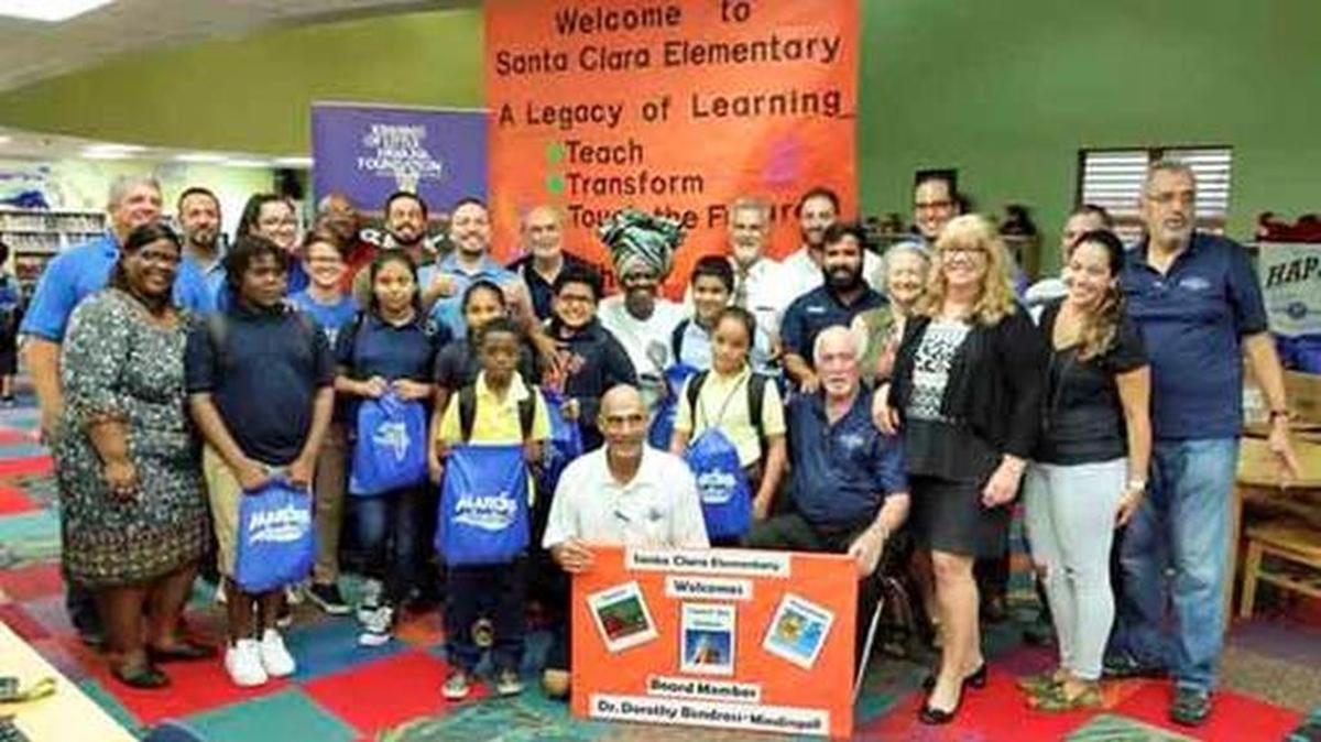 Miami-Dade School Board Vice Chairwoman Dorothy Bendross-Mindingall, center back, joined forces with the Miami Marlins and the Kiwanis Club of Little Havana to donate backpacks and school supplies to five Miami-Dade County schools during the first week of school.