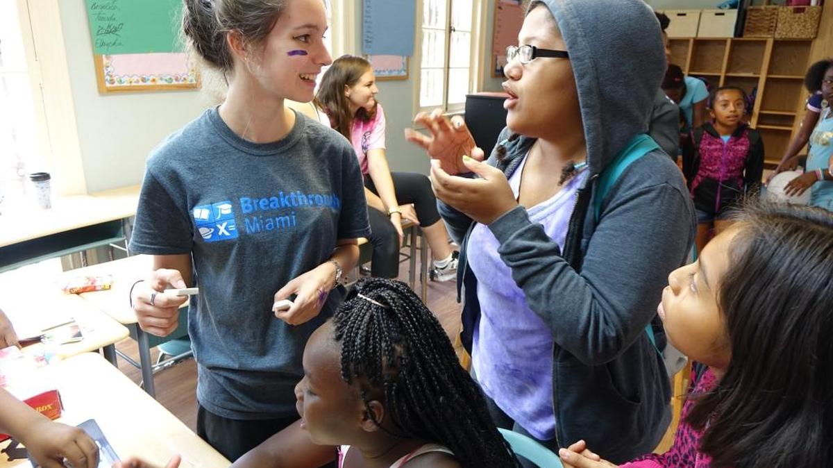 A group of students play board games with a Teaching Fellow at the Carrollton Breakthrough site. The Carrollton site is all-female which provides a unique environment for the young women to empower themselves.