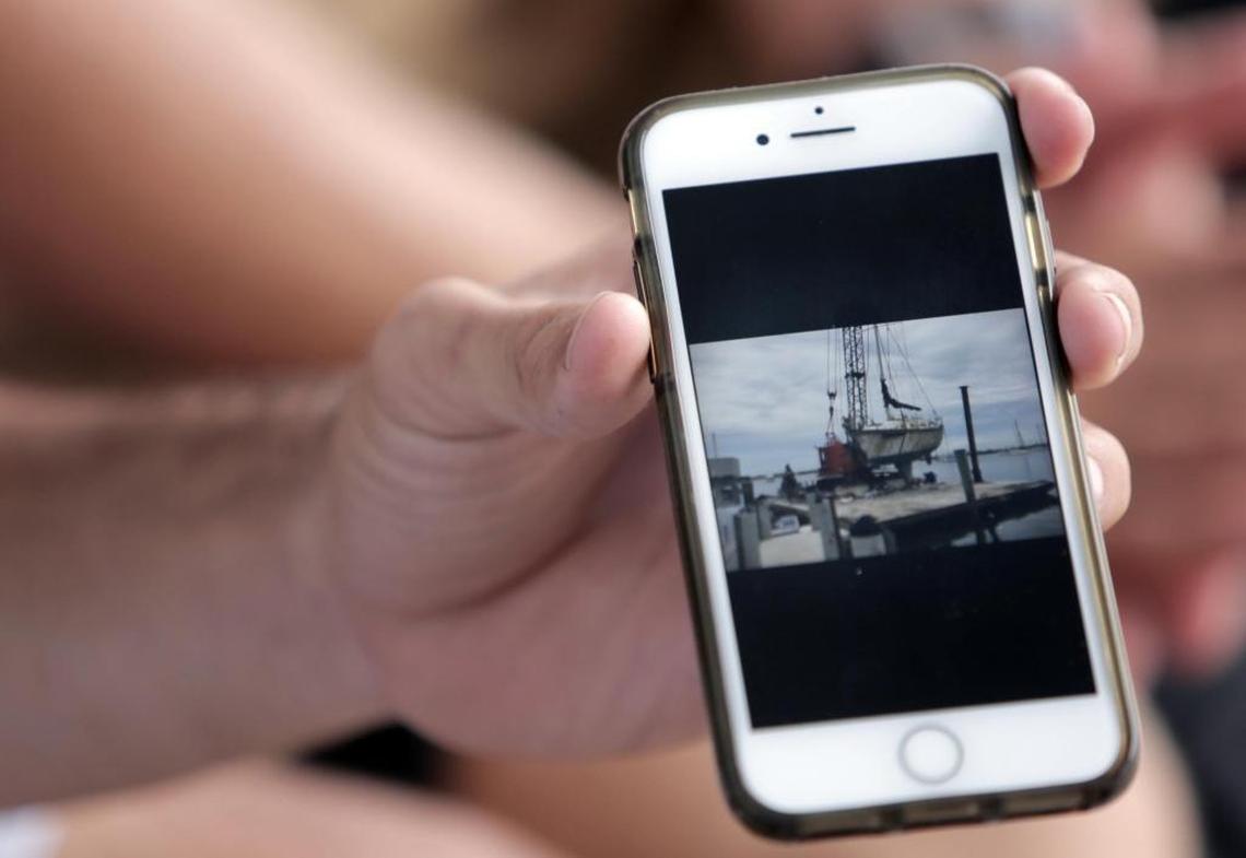 High school senior Randy Culmer, 17, shows a picture on his phone of a boat that he recently helped his family salvage during the recovery from Hurricane Irma.