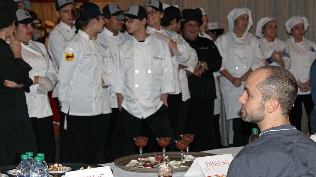 Students watch as the judges at The Education Fund's A Taste of Education event taste the dessert course.