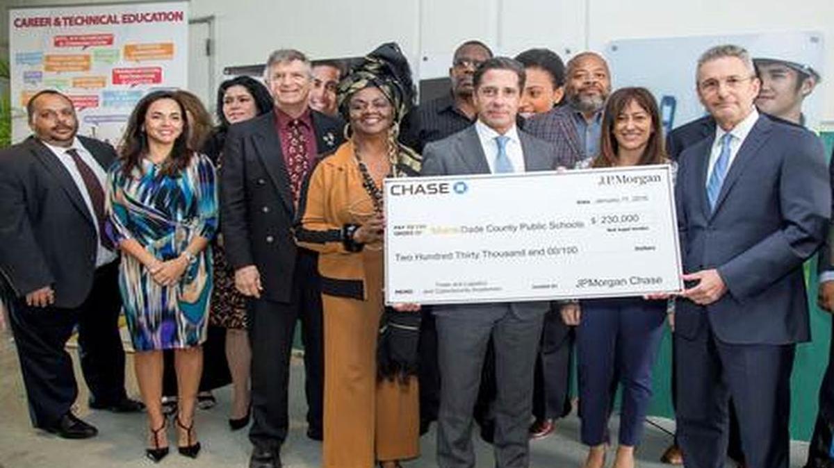 Guillermo Castillo, head of the Chase Commercial Bank in South Florida, presents Miami-Dade County Public Schools Superintendent Alberto Carvalho with a $230,000 grant from JPMorgan Chase for the installment of two new academies in Miami-Dade.