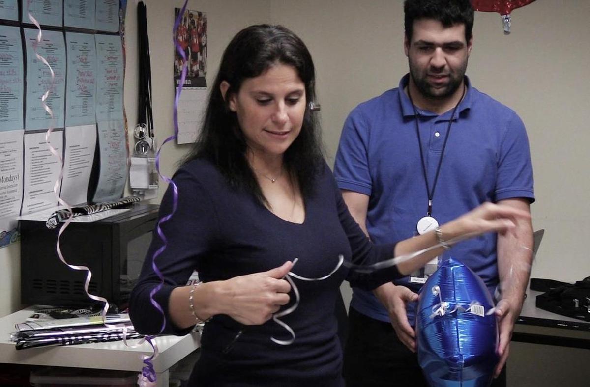 Teacher Ivette Amador, left, works on a balloon order with Gabriel Cartamil, a student at John A. Ferguson Senior High School. Amador uses the Falcon Gift Shop to teach special needs students business skills.