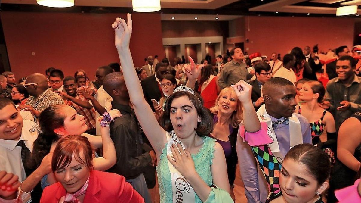 Prom Queen Lisa Sprung, center, of Miami Coral Park Senior High on the crowded dance floor at a special prom for those with autism spectrum disorder at the DoubleTree by Hilton Miami Airport & Convention Center on Tuesday, May 16, 2017. School Board member Mari Tere Rojas, in background, is dancing along with the students.