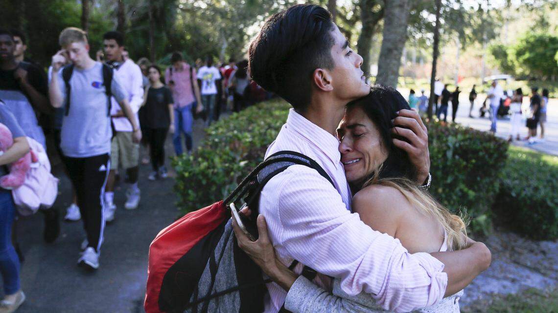 After a gunman opened fire on campus, Jorge Zapata, 16, a sophomore, hugs his mother, Lavinia Zapata, outside Marjory Stoneman Douglas High School in Parkland on Feb. 14, 2018.