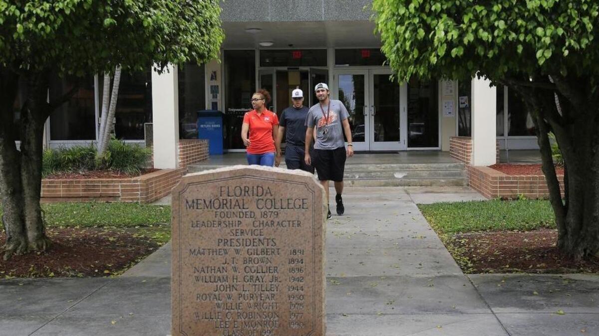 Seniors Taylor Payne, 23, left, Brian Gonzalez, 22, and Ruben Sanchez, 23, right, exit the library at Florida Memorial University in Miami Gardens.