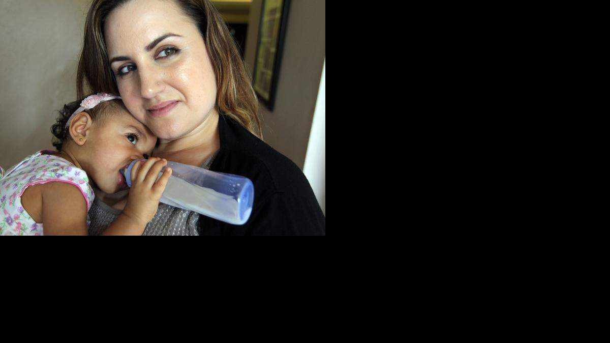 
Monica Toranzo-Howell and her baby Celeste, in their Miramar home, September 19, 2014. Howell and other teachers are campaigning for Miami-Dade schools to establish policies to allow lactating teachers time and space to pump breast milk.



