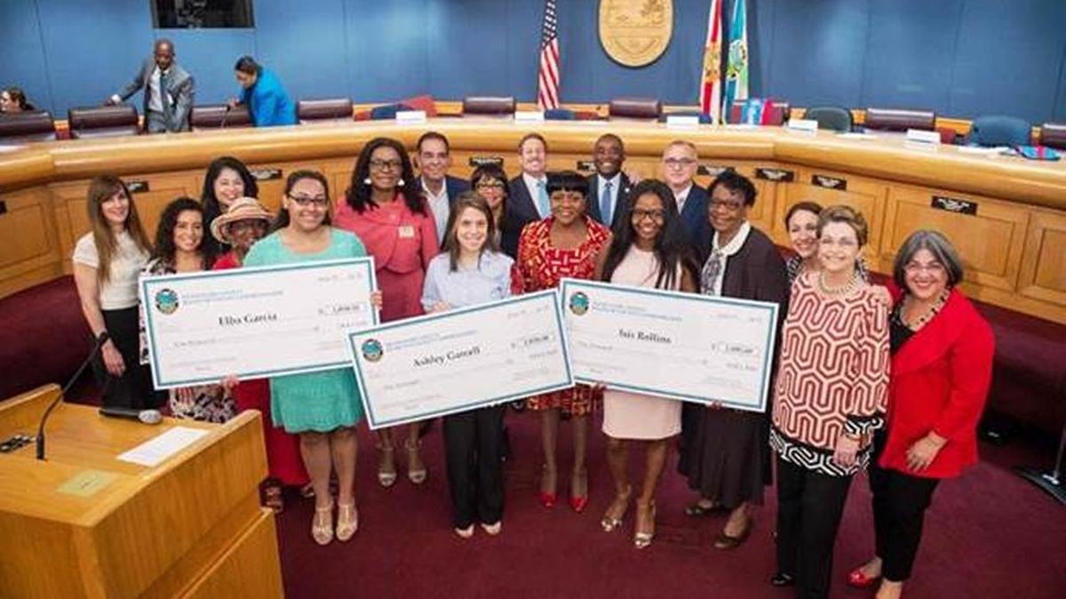 The Miami-Dade County Commission for Women, pictured, recently awarded $1,000 scholarships to Ashley Garcell, Elba Garcia, and Isis Rollins, center, of the Young Women’s Preparatory Academy in Miami.