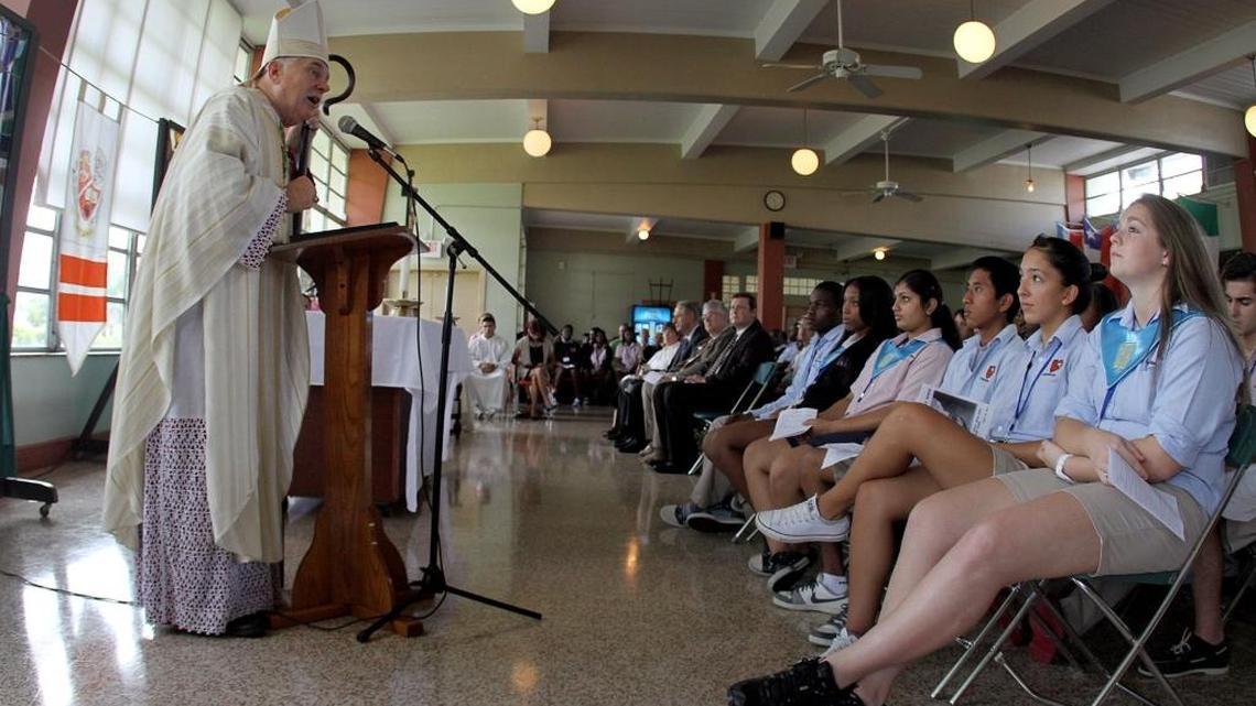 Archbishop Thomas Wenski, left, gives the Opening Mass celebrating the new school year at Archbishop Curley Notre Dame in Miami on Tuesday, Aug. 28, 2012.