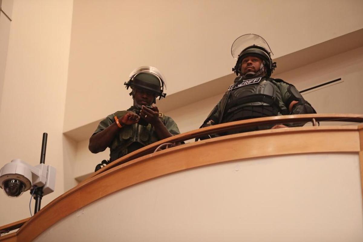 Two Polk County sheriff’s deputies stand in riot gear in the balcony of the Phillips Center at the University of Florida in Gainesville. White Nationalist Richard Spencer spoke there on Thursday, Oct. 19, 2017, drawing supporters and protesters.