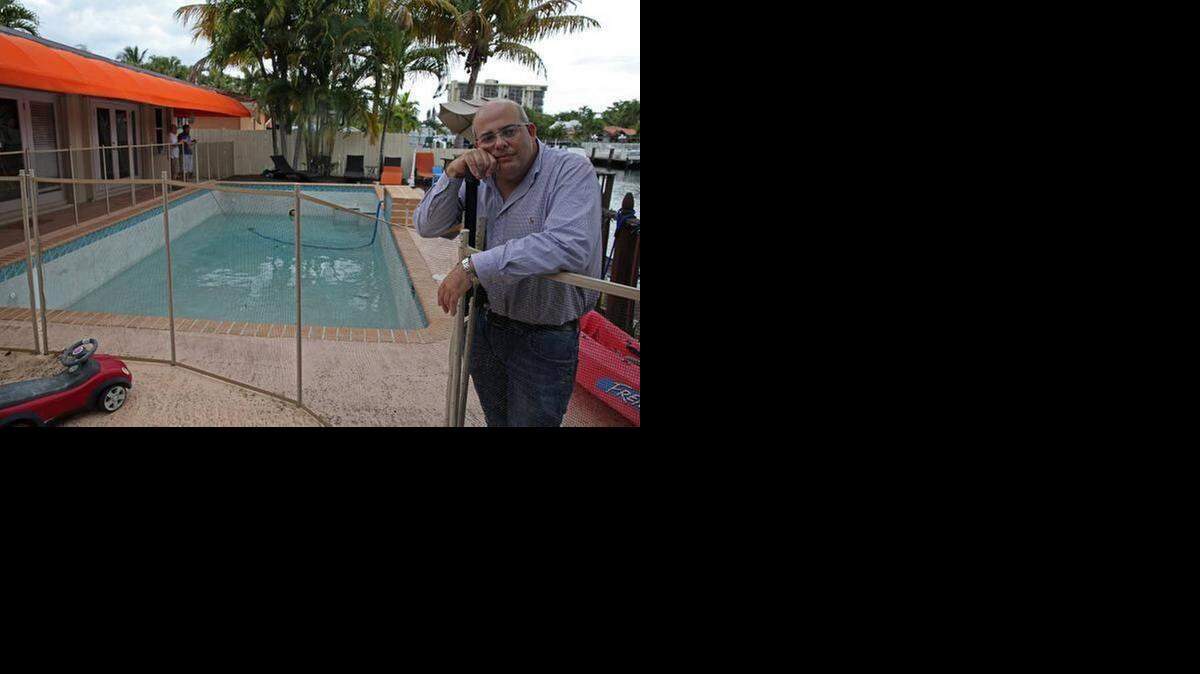 
Christopher Sloan, at his Keystone Point home, Thursday, April 17, 2014. His son, Calder, 7, was electrocuted in the pool April 13, 2014, possibly due to faulty wiring of the pool light.
