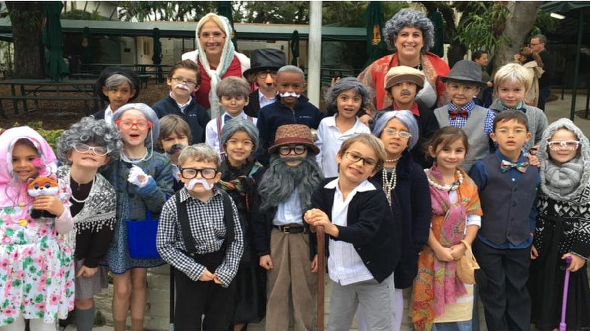 The senior Kindergarten students at St. Stephen's Episcopal Day School learned to count to 100 by the 100th day of school. To celebrate, students created vests made from paper bags using the 100 items they chose and came to school dressed as 100-year-olds. Martiza Urdaneta and Susie Oldham are pictured with their classes on the 100th day of school.