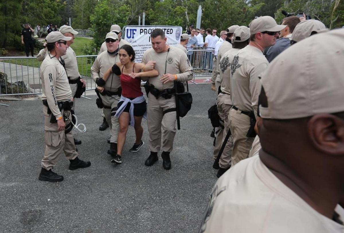 Former UF student, Samantha Schuyler, is dragged away by FHP troopers after being denied entrance to the Phillips Center at the University of Florida in Gainesville on Thursday, Oct. 19, 2017. White nationalist Richard Spencer spoke there on Thursday, drawing more protesters than supporters.
