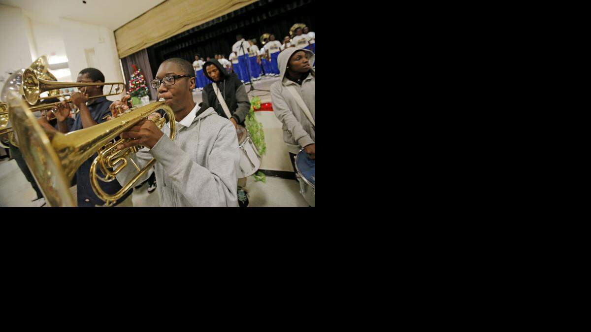 
Lewis Anthony, a junior at Miami Jackson Senior High, plays during a multischool band arrangement at Allapattah Middle School's "12 Nights of Literacy" event.


