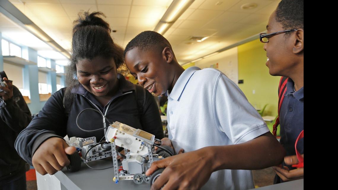 
Sixth graders Isabelle Augustin, 12, left, Elie Alcide, 12, and Hymler Lagou, 12, right compare their robots to one each others machine. Students participated in the EV3 Robotics Program that offers kids a chance to build their own robots using Legos which part of a grant in which North Miami Middle and Edison K-8 Center collaborate with Florida International University to help spark an interest in STEM related concepts and careers at North Miami Middle School on Tuesday, May 26, 2015.
