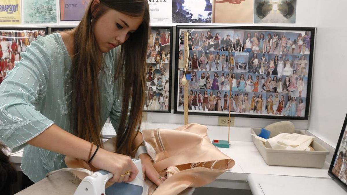 Design and Architecture Senior High student Azura Wannman, 17, presses hems on a dress in preparation for an upcoming show at the Moore Building in the Design District, Monday, May 9, 2011, in Miami.
