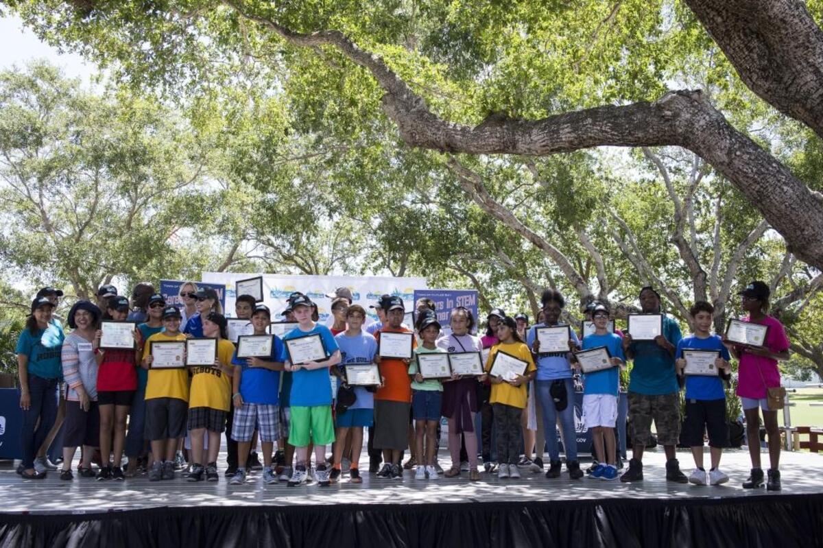 Cutler Bay Middle School students display certificates they received on behalf of the STEM robotics summer camp at Cutler Ridge Park on Saturday, Aug. 12, 2017.