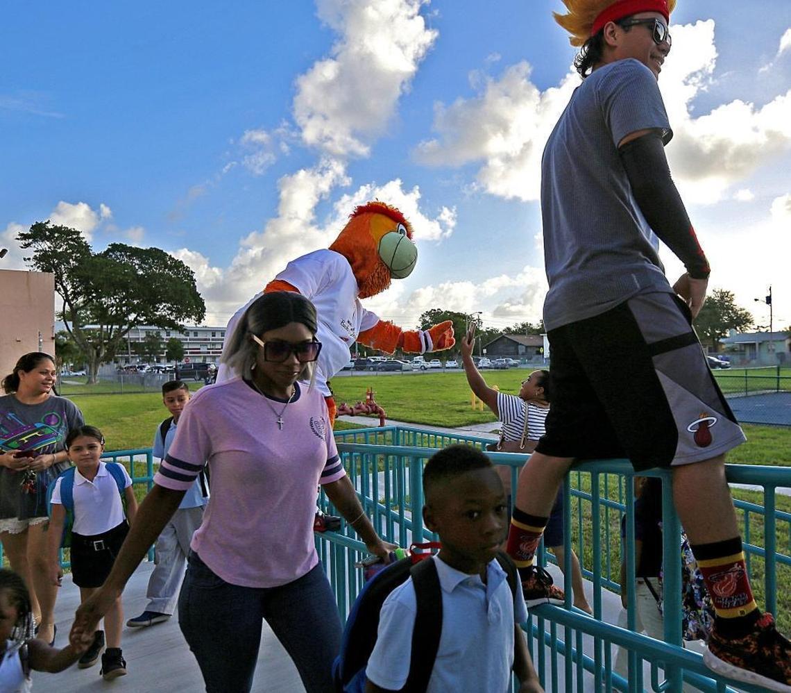 Burnie and members of the Miami Heat Xtreme squad greet students and parents during the first day of school at Jesse J. McCrary Elementary in Miami on Monday, August 21, 2017.