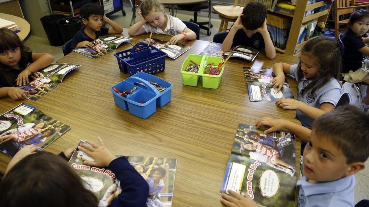Children in a kindergarten class read at Henry S. West Laboratory School in Coral Gables, which has instituted a new policy this year to significantly decrease the amount of homework given to students. Instead, the school is encouraging parents to spend more ‘quality, unstructured time’ at home with their children in the evenings.