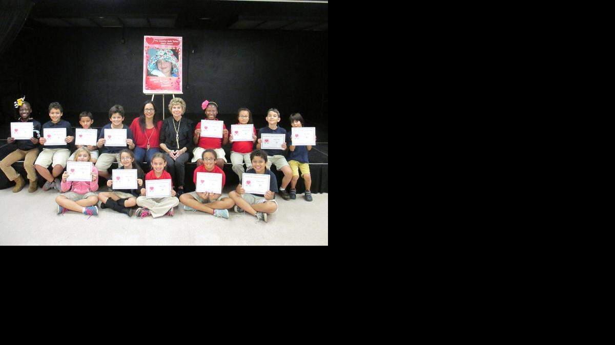 
HEART AWARD WINNERS: These Fienberg-Fisher K-8 Center students stand with their Assistant Principal, Aisha Marrero, and instructor Claire Warren while holding their Jennifer Beth Turken Heart Awards. 
