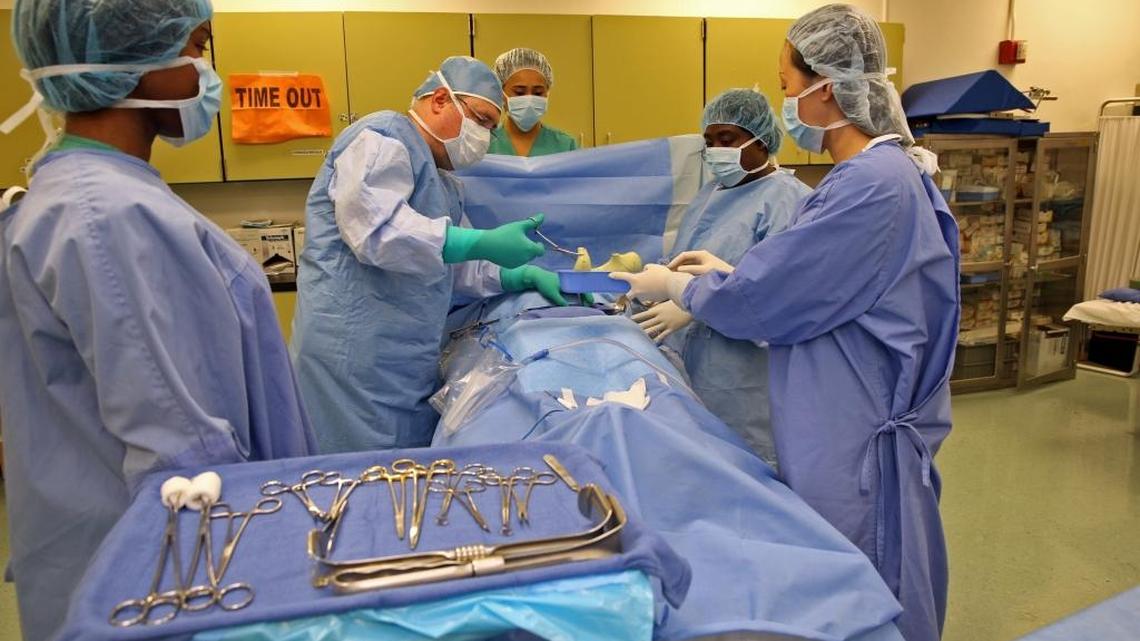 Surgical technology students at Lindsey Hopkins Technical College perform a mock surgery.